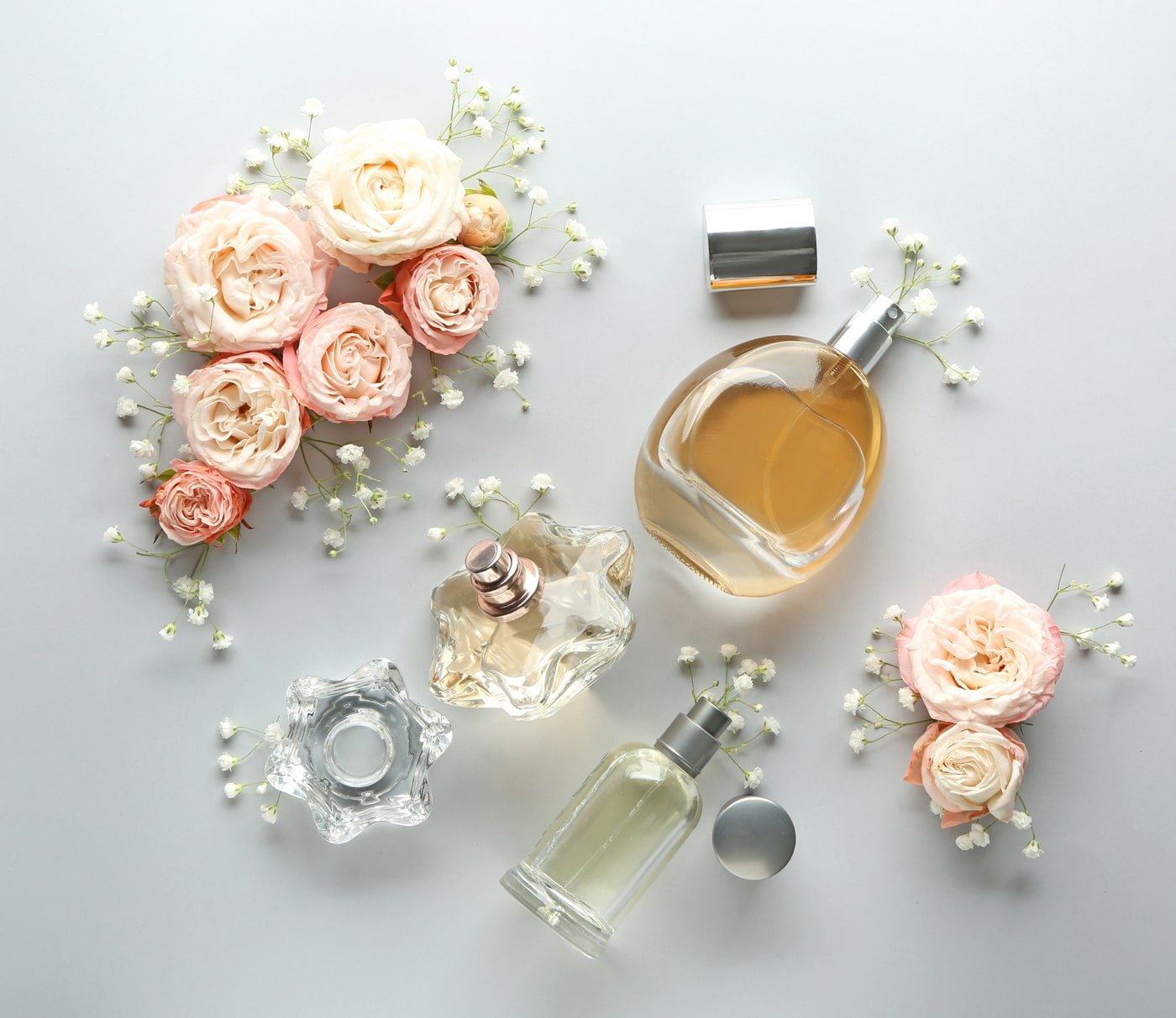 Perfume bottles arranged with roses